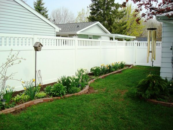 White Backyard Fence
 Landscaping along white privacy fence