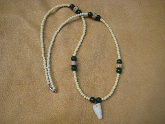 Alligator Tooth Necklace
 Alligator tooth necklace by thegreenwolf on Etsy