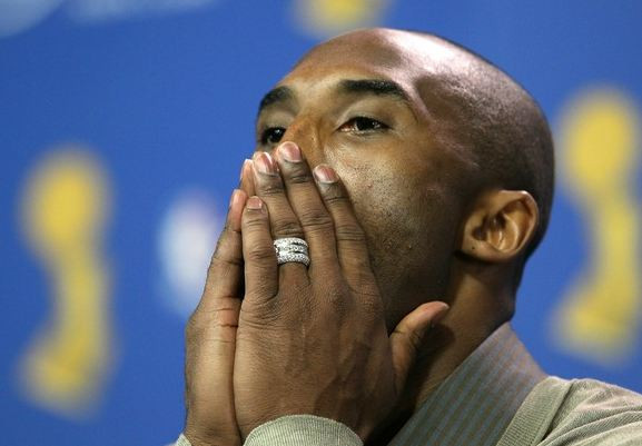 Kobe Bryant Wedding Band
 Kobe Bryant covers his mouth with both hands during a post