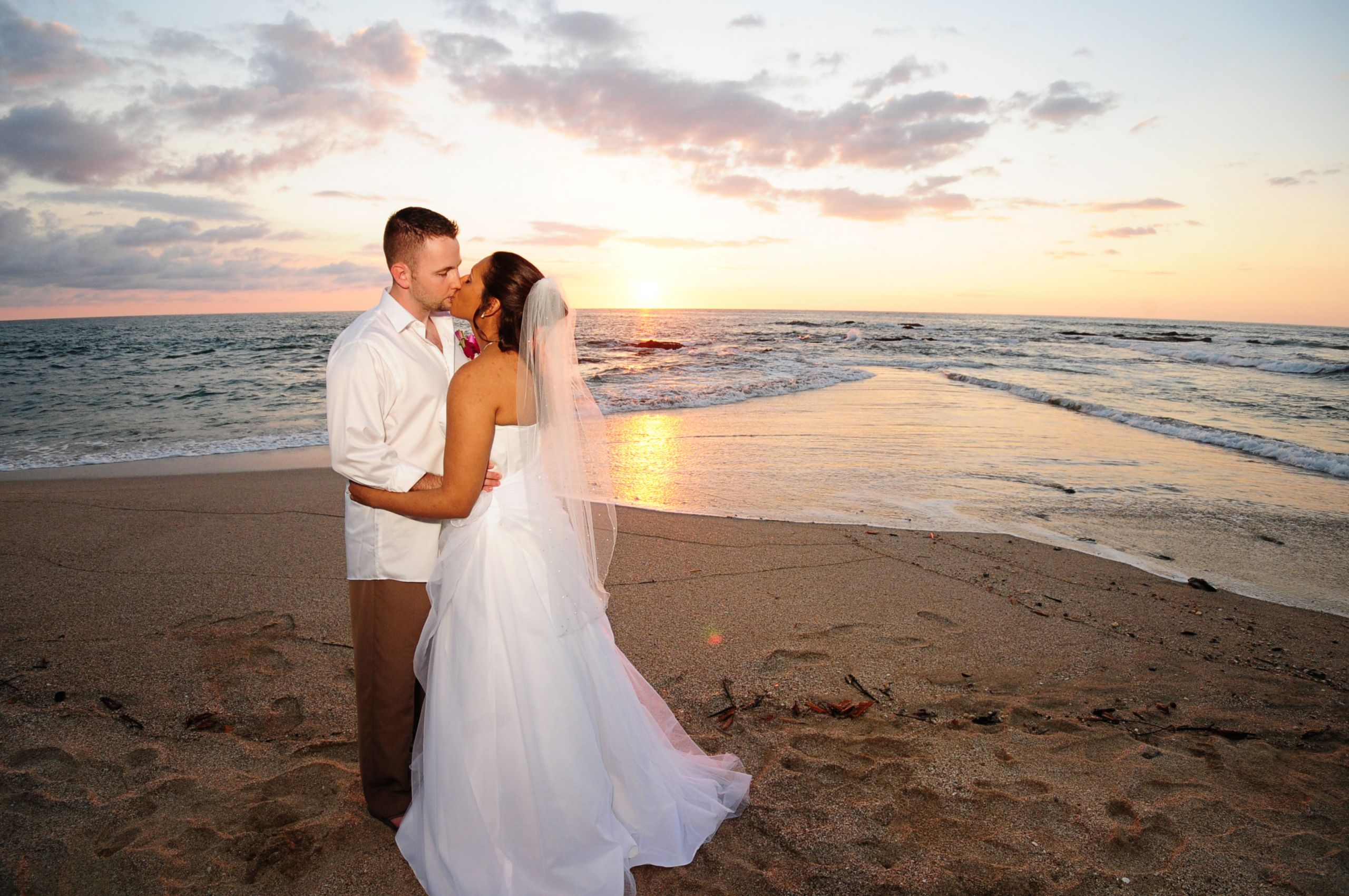 Sunset Beach Weddings
 Beach wedding couple kissing after ceremony