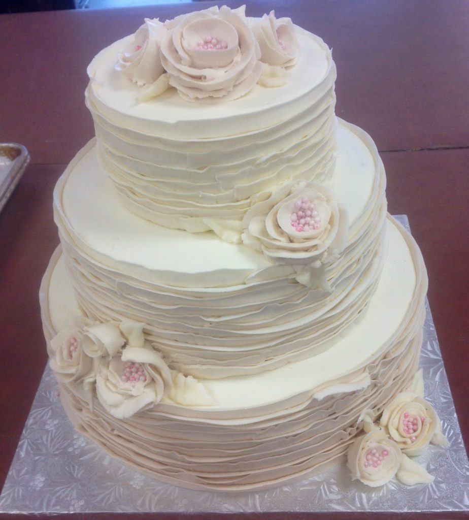 Wedding Cake Frosting
 Tiered Streamlined Wedding Cake with Fresh Flowers and