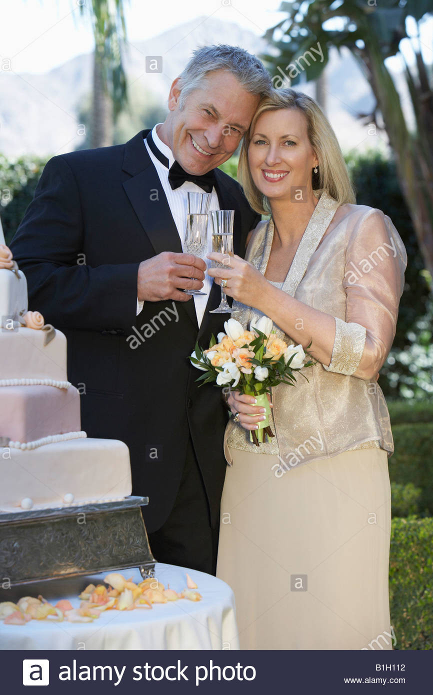 Wedding Gift Ideas For Middle Aged Couple
 Middle aged couple toasting near wedding cake portrait