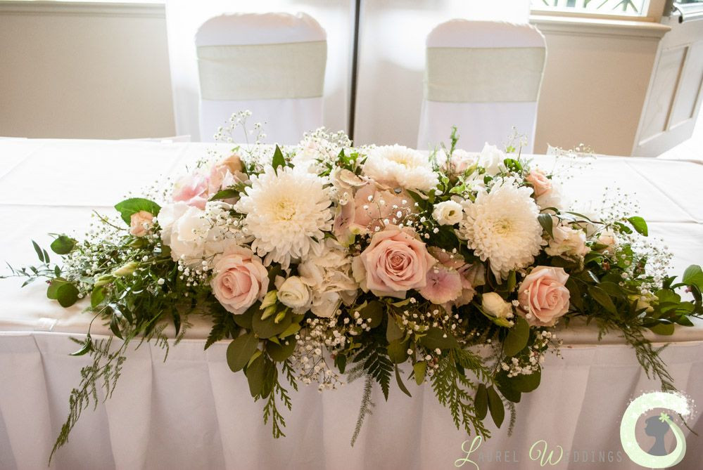 Wedding Table Flower Arrangements
 Blush pink and ivory ceremony table arrangement at The