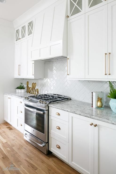 White Kitchen Cabinet Handles
 A stainless steel oven range sits against white