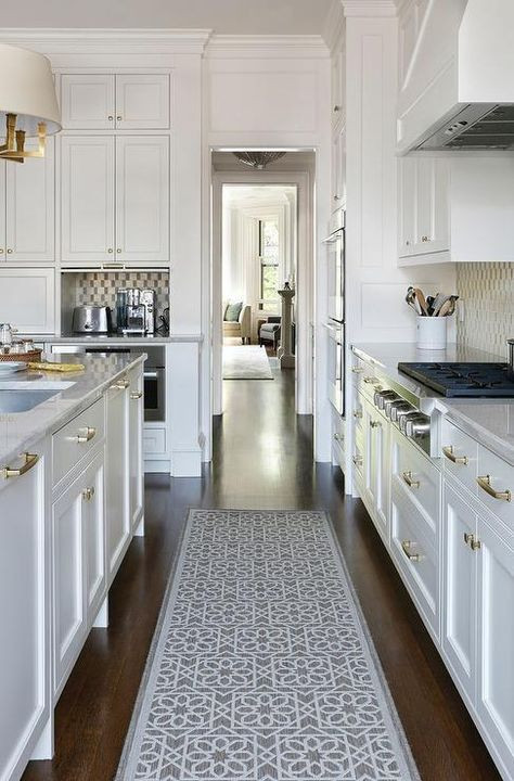 White Kitchen Rugs
 Stunning white kitchen boasts a gray trellis runner placed