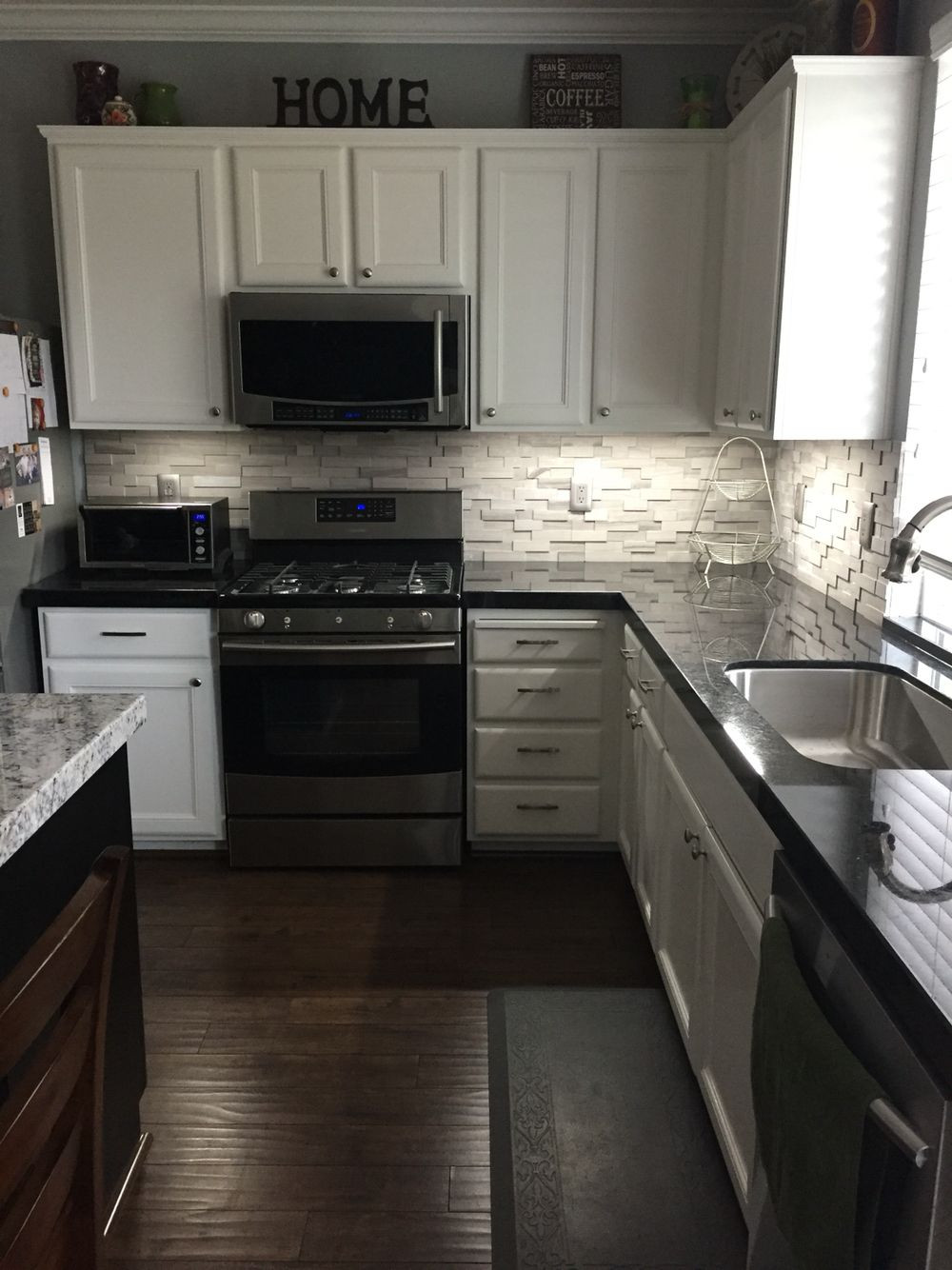 White Kitchen With Black Granite
 Black granite with a gray stone backsplash in 2019